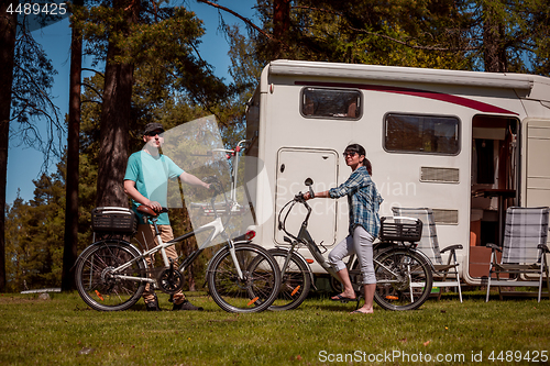 Image of Woman with a man on electric bike resting at the campsite.