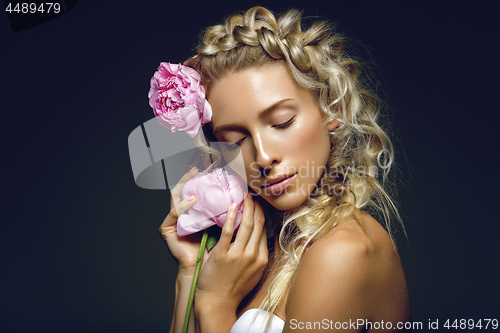 Image of Beautiful girl with peony flower