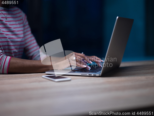 Image of black businesswoman using a laptop in startup office