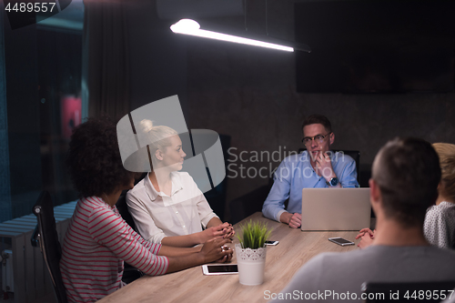 Image of Multiethnic startup business team in night office