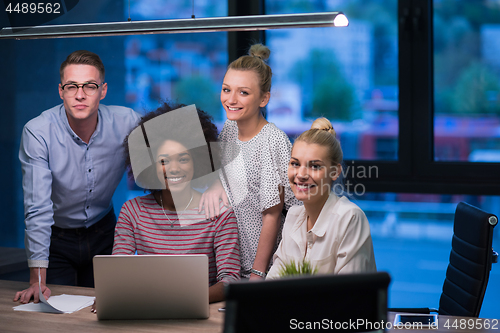 Image of Multiethnic startup business team in night office