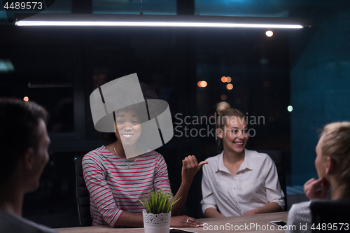 Image of Multiethnic startup business team in night office