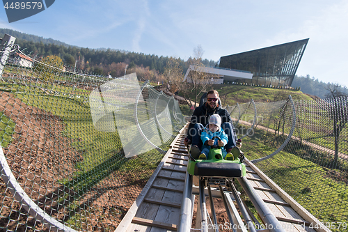 Image of father and son enjoys driving on alpine coaster