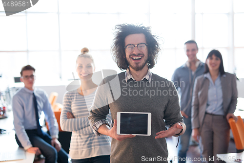 Image of Portrait of a young businessman holding tablet