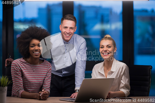 Image of Multiethnic startup business team in night office