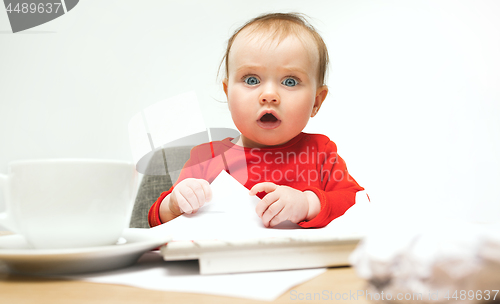 Image of Happy child baby girl toddler sitting with keyboard of computer isolated on a white background