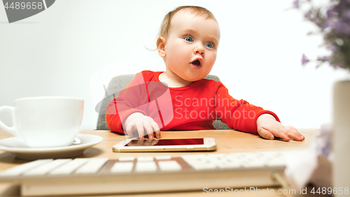 Image of Happy child baby girl toddler sitting with keyboard of computer isolated on a white background