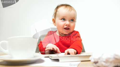Image of Happy child baby girl toddler sitting with keyboard of computer isolated on a white background