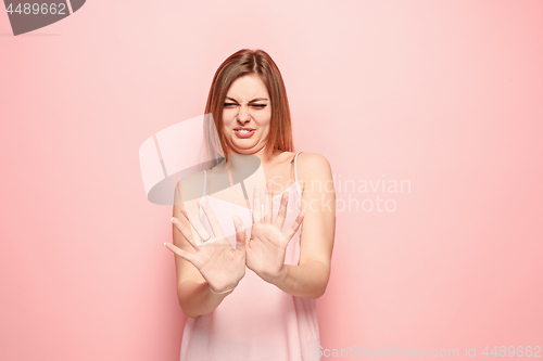 Image of Let me think. Doubtful pensive woman with thoughtful expression making choice against pink background