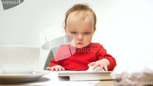 Image of Happy child baby girl toddler sitting with keyboard of computer isolated on a white background