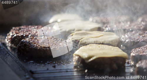 Image of Preparing burgers at the barbecue outdoors