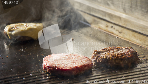 Image of Preparing burgers at the barbecue outdoors