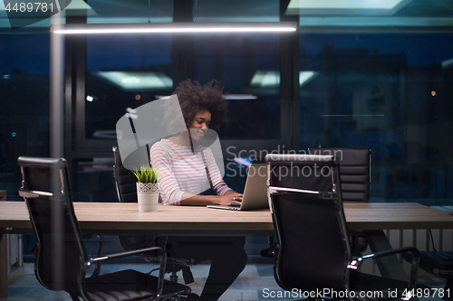 Image of black businesswoman using a laptop in startup office