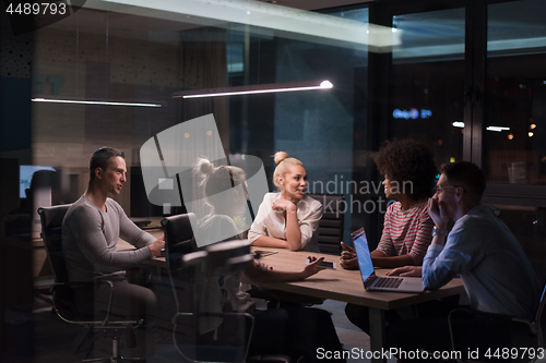 Image of Multiethnic startup business team in night office