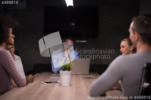 Image of Multiethnic startup business team in night office