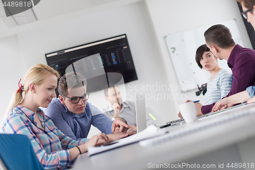 Image of Two Business People Working With laptop in office