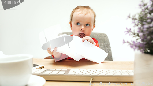 Image of Happy child baby girl toddler sitting with keyboard of computer isolated on a white background