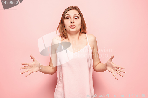 Image of Beautiful woman looking suprised isolated on pink