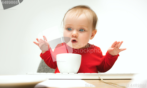 Image of Happy child baby girl toddler sitting with keyboard of computer isolated on a white background