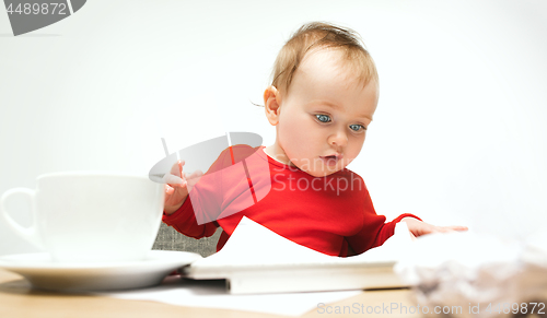 Image of Happy child baby girl toddler sitting with keyboard of computer isolated on a white background