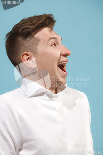 Image of The happy business man standing and smiling against studio background.