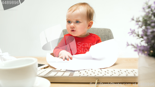 Image of Happy child baby girl toddler sitting with keyboard of computer isolated on a white background