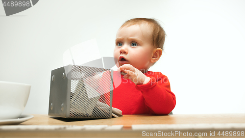 Image of Happy child baby girl toddler sitting with keyboard of computer isolated on a white background