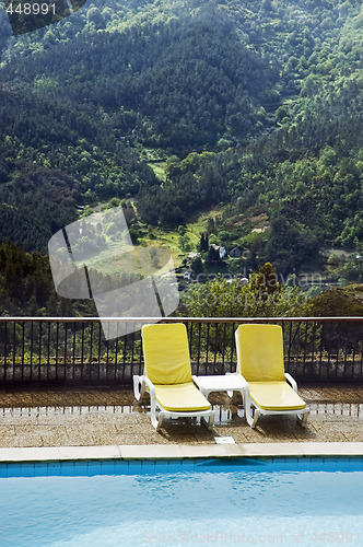 Image of Long chairs by the pool 2