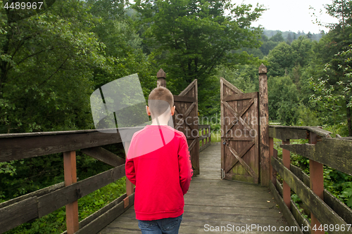 Image of Boy Goes Through the Gates to a New Life