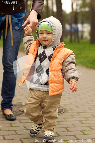 Image of Baby Learning to Walk in Park