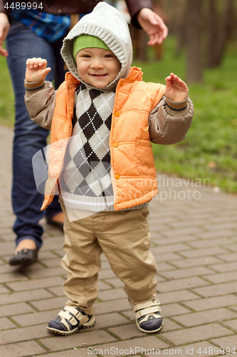 Image of Baby Learning to Walk in Park