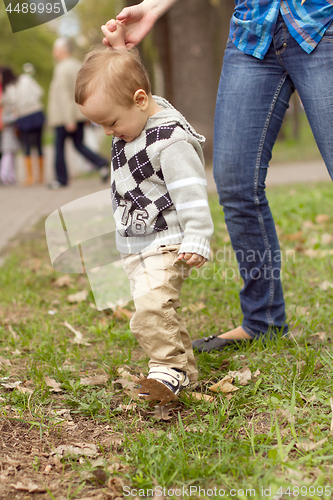 Image of Baby Learning to Walk in Park