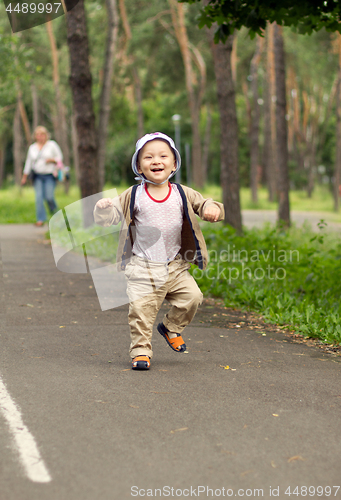 Image of Baby Learning to Walk in Park