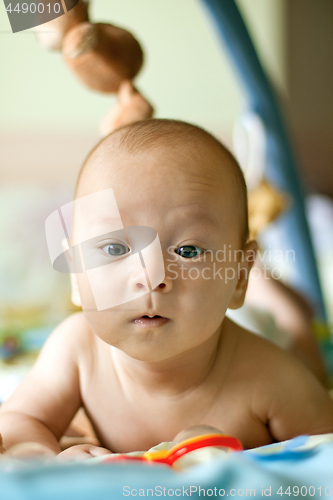 Image of Baby Boy or Girl lying Down in the Bed