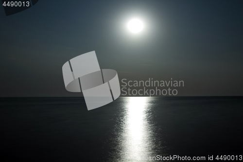 Image of Moon above the water with moonlight