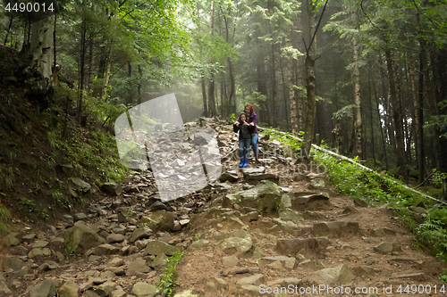 Image of Mother and son in the mystic green foggy forest