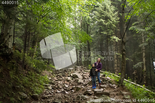 Image of Mother and son in the mystic green foggy forest