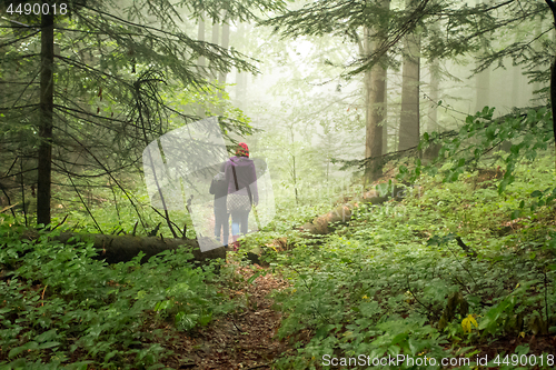 Image of Mother and son in the mystic green foggy forest