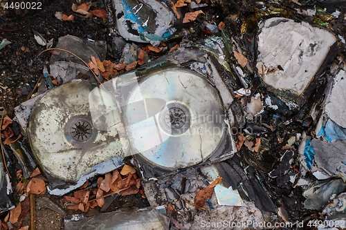 Image of CD\'s thrown away in garbage dump piles