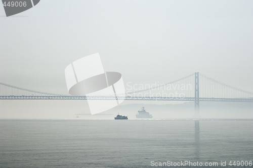 Image of Ferrys crossing the Tagus river in a foggy morning