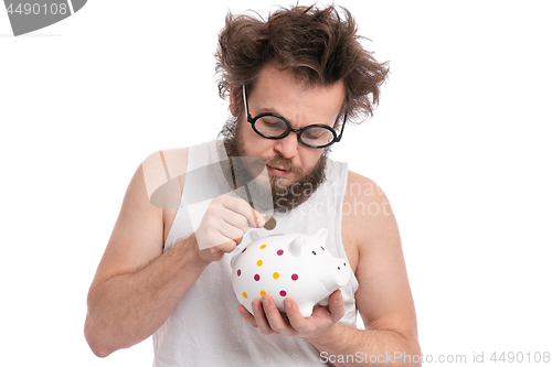 Image of Crazy bearded man with piggy bank