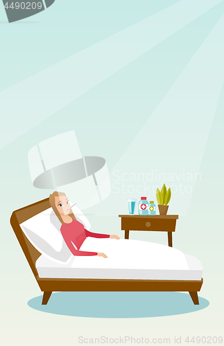 Image of Sick woman with thermometer laying in bed.