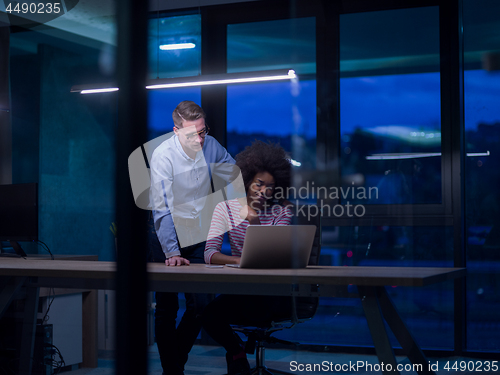 Image of Multiethnic startup business team in night office