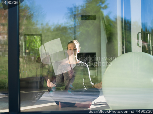 Image of young woman doing morning yoga exercises