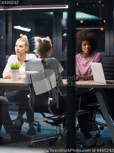 Image of Multiethnic startup business team in night office