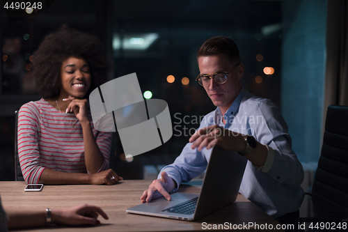 Image of Multiethnic startup business team in night office