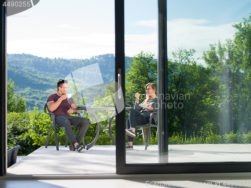 Image of couple enjoying morning coffee and breakfast