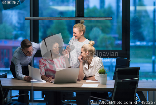 Image of Multiethnic startup business team in night office