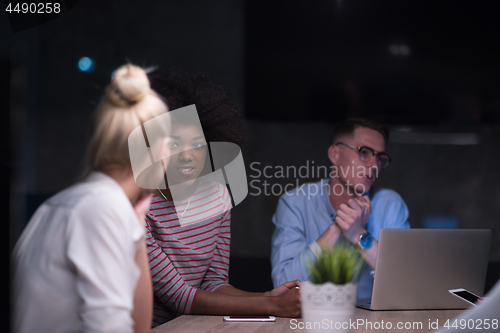 Image of Multiethnic startup business team in night office