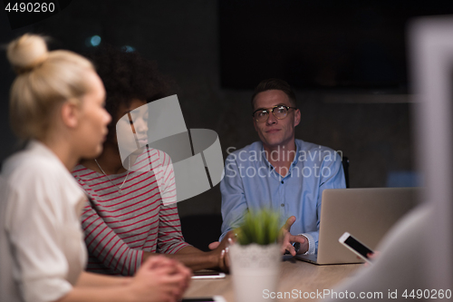 Image of Multiethnic startup business team in night office